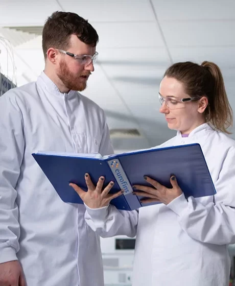 Lab technicians reviewing a report